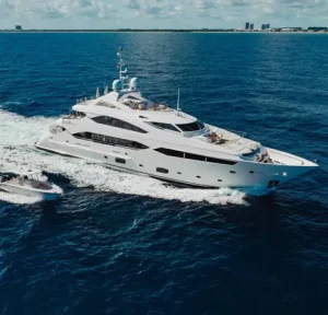 Aerial view of About Time Motor Yacht cruising with a tender alongside.