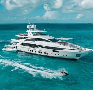 Aerial view of motor yacht Emina with tender boat in crystal blue water