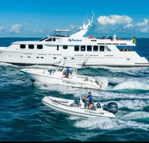Reflections Motor Yacht cruising alongside its chase boat and tender.
