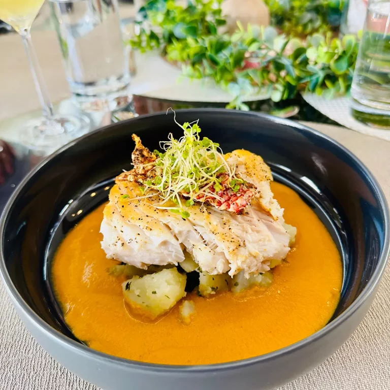Gourmet fish entrée with saffron sauce on ALLORA yacht