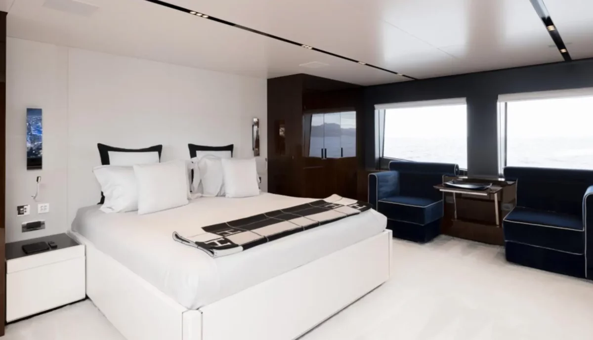 Primary suite on Lady First yacht with king bed and large windows
