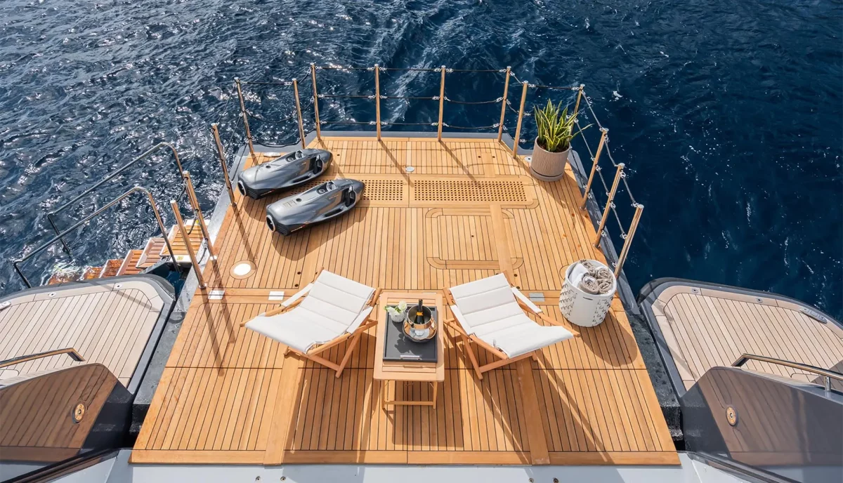 M yacht beach club setup with SeaBobs, lounge chairs, and sea access