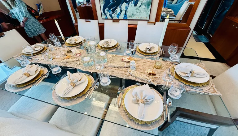 Nautical dining table decor with shells and woven chargers