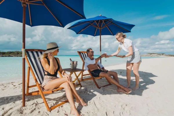 Exclusive Beach Service by Emina Yacht Crew Crew service on beach with yacht Emina anchored offshore