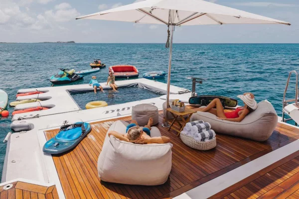 Emina Yacht Beach Platform with Water Sports and Relaxation Area Luxury yacht Emina beach club with swimming platform, water toys and comfortable loungers under sun umbrella