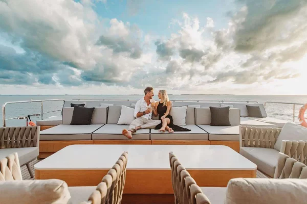 Romantic Sunset Experience on Yacht Emina’s Deck Couple enjoying champagne on yacht Emina's upper deck at sunset